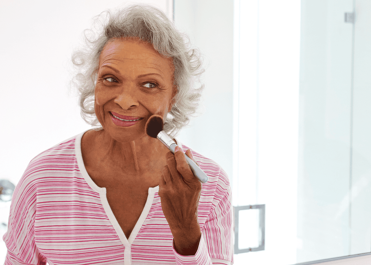 Senior Woman Looking at Reflection in Bathroom