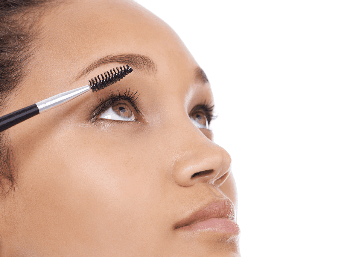 woman using spoolie brush on eyebrows