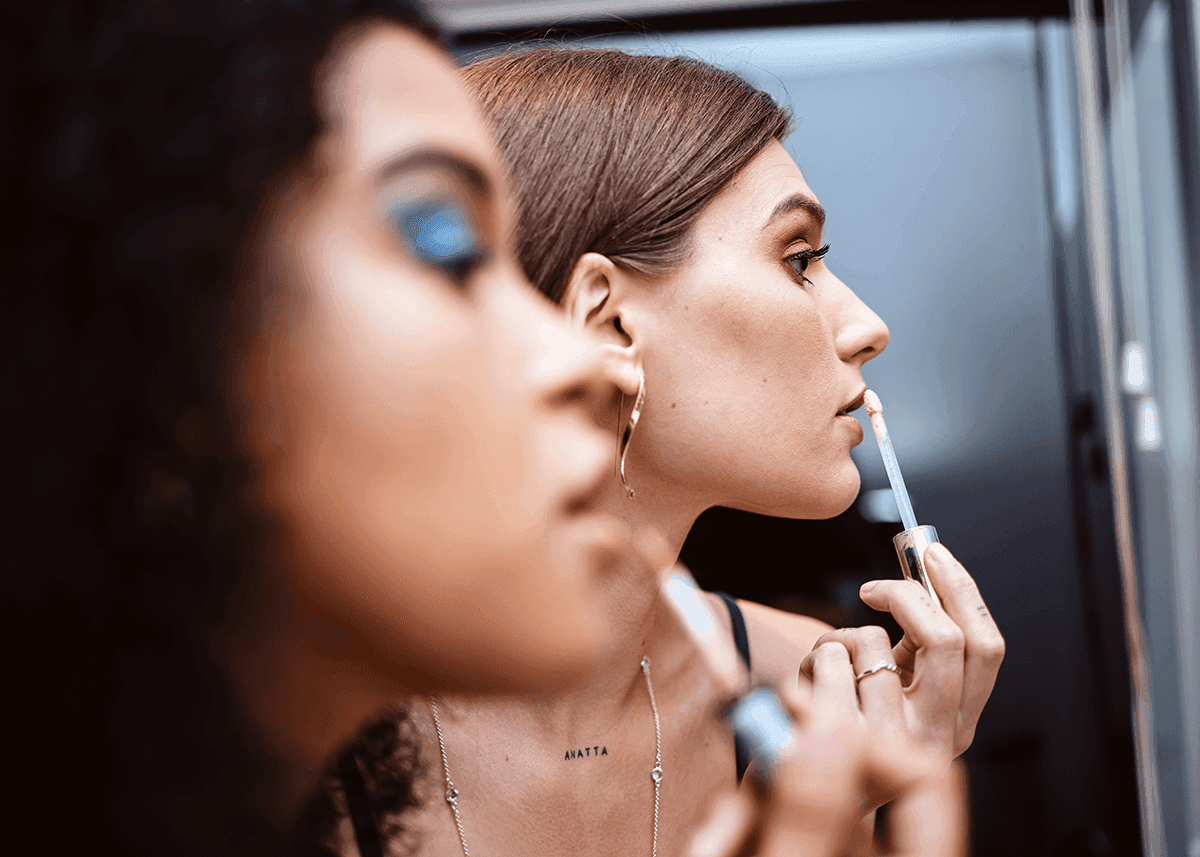 women backstage applying stage makeup before a show