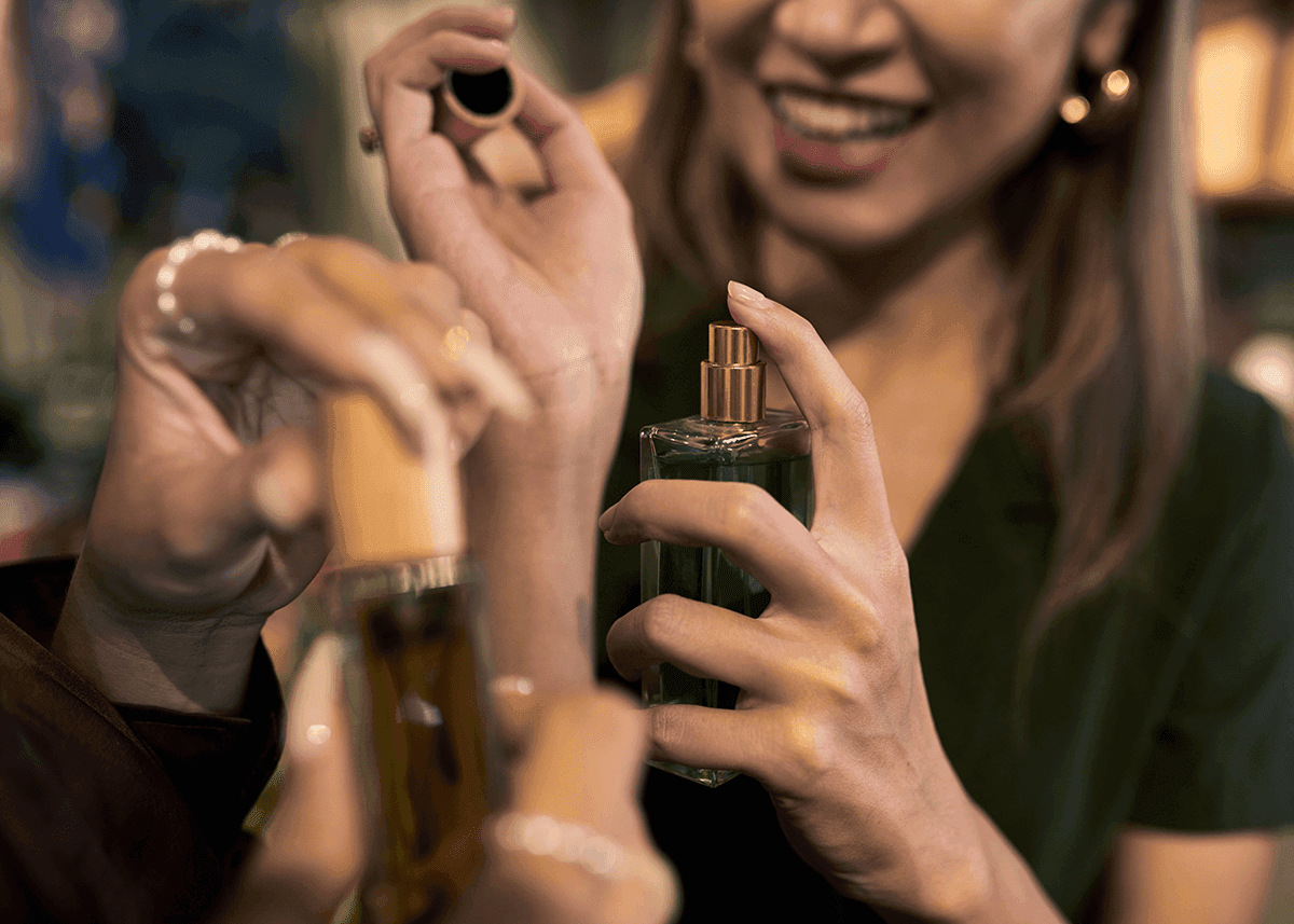 women trying perfume on wrists