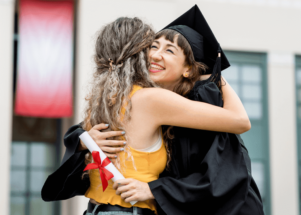 Friends hugging at graduation ceremony