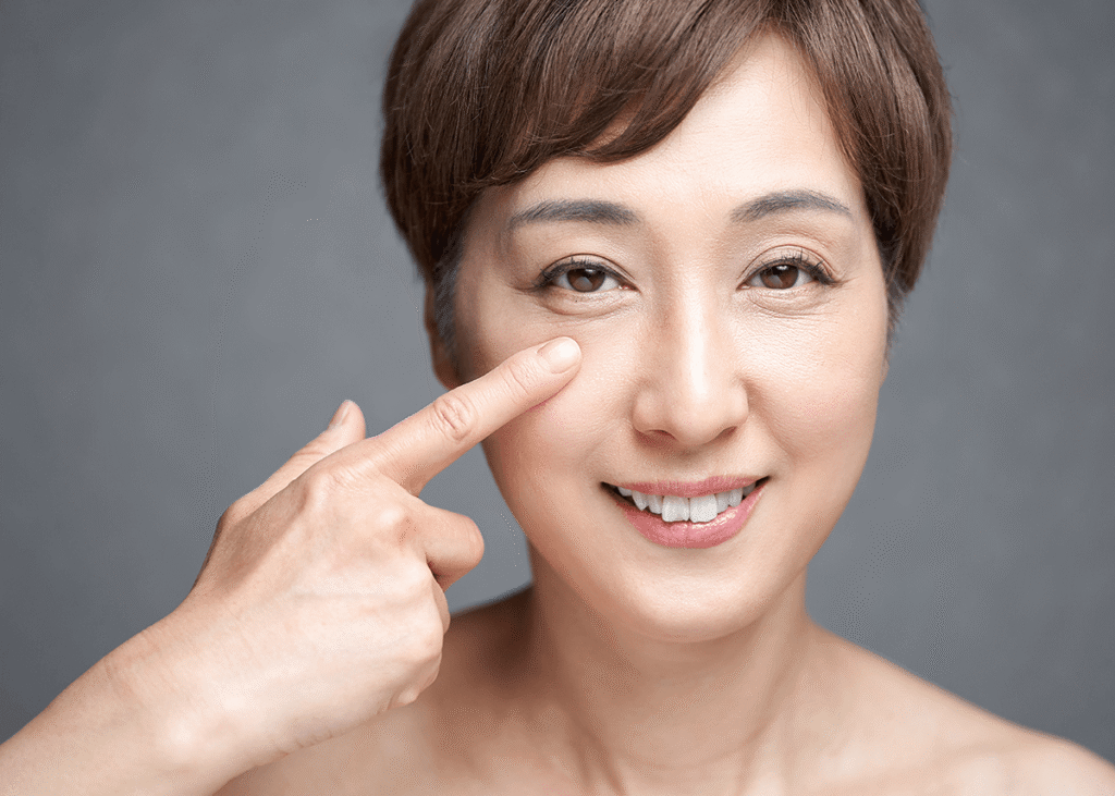 Middle aged woman pointing to her eye