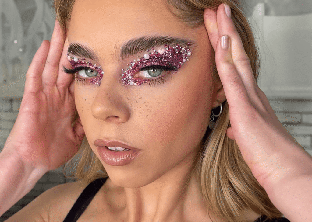 Glitter eye makeup with gems applied