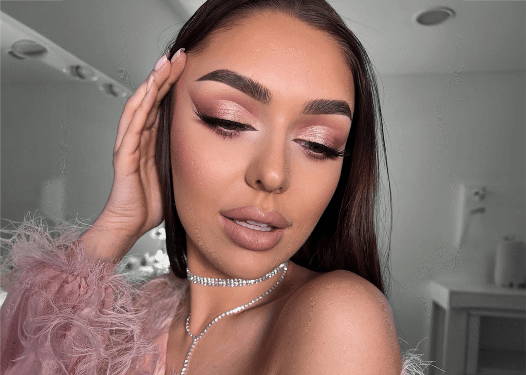 Pink eyeshadow posed with pink ruffle dress