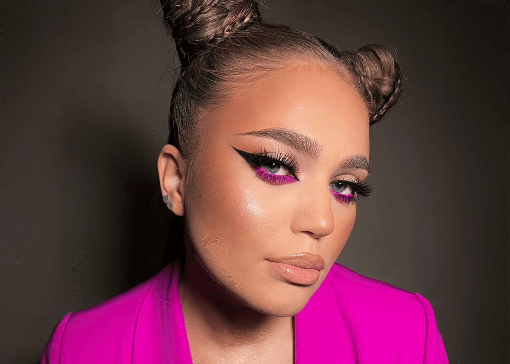 Pink eyeshadow pink jacket with space buns