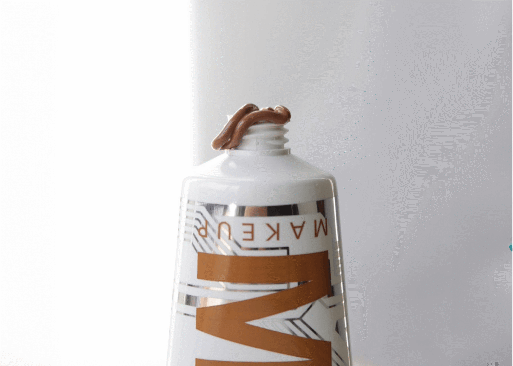 liquid bronzer being squeezed from a tube