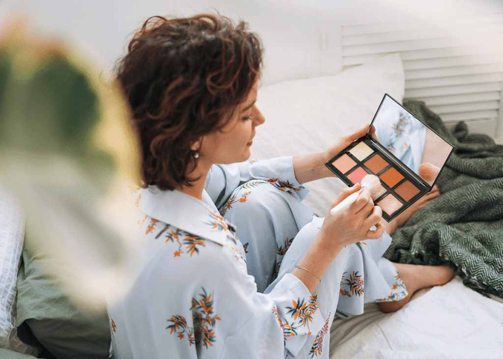 Girl looking through nude eyeshadow pallete