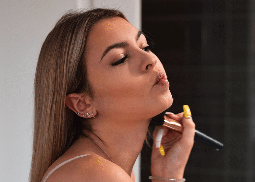 Girl applying bronzer to face